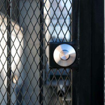 stock-photo-gated-outside-staircase-close-up-door-with-one-sided-cylinder-deadbolt-and-exterior-plate-caged-1882239688